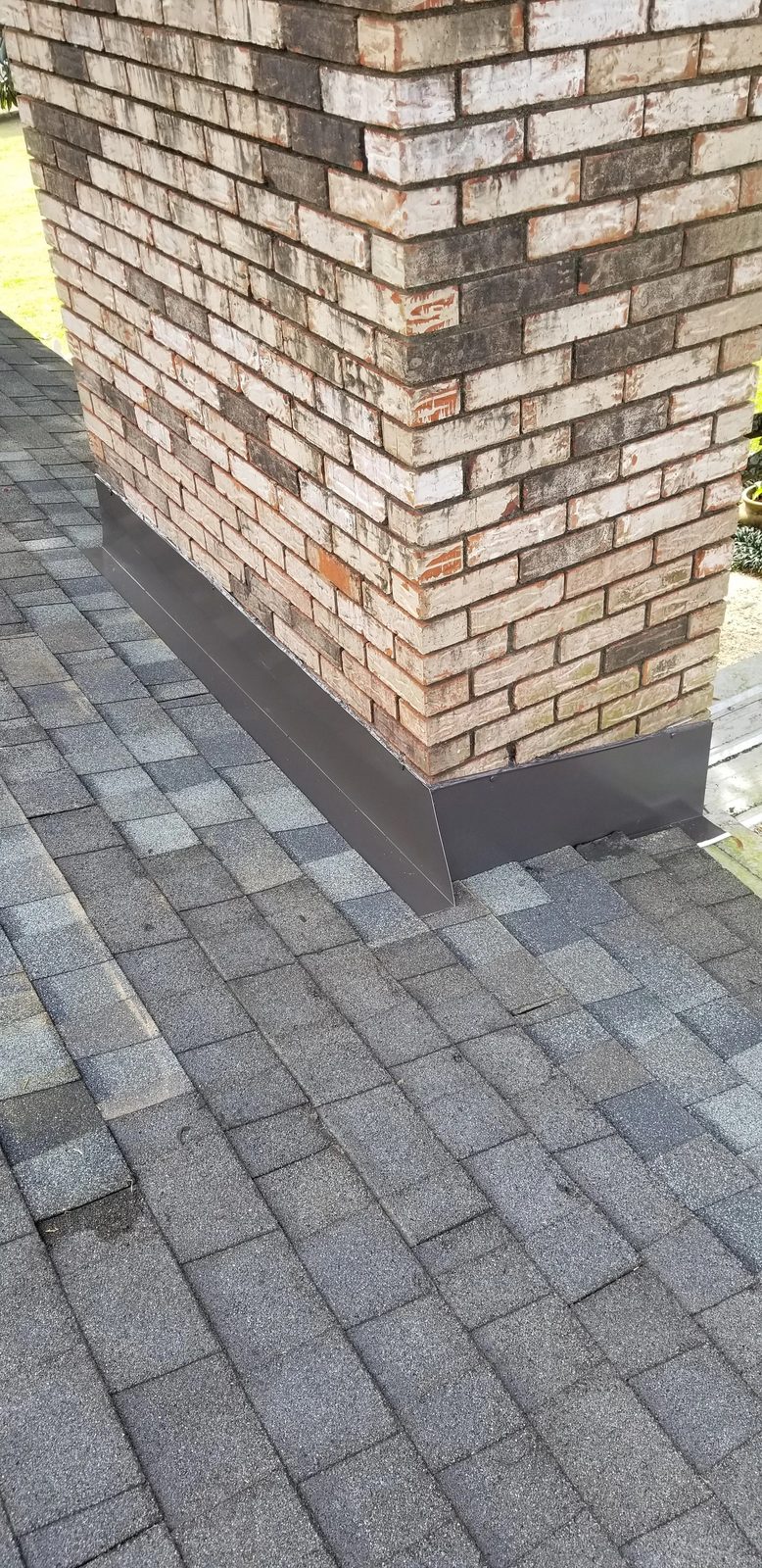 Completed chimney flashing corner detail with shingles woven in